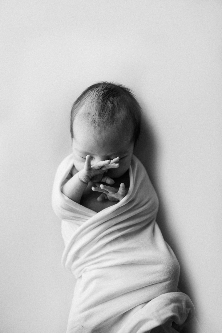 black and white newborn baby-swaddled baby-tired newborn baby