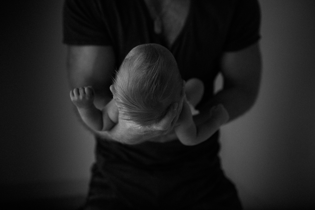 newborn baby in daddy's hands-newborn and daddy-black and white newborn